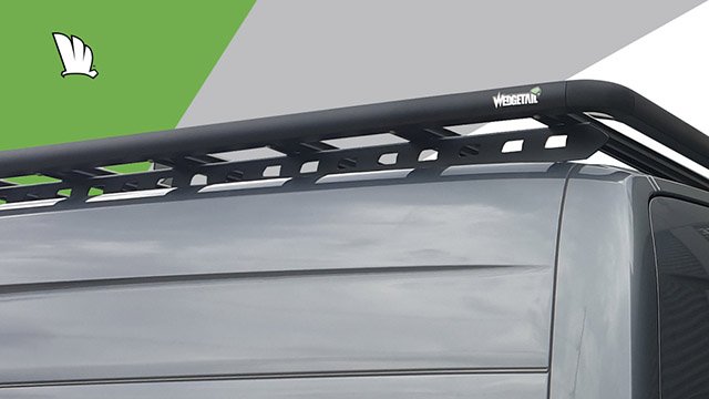 Rear corner of a Mercedes-Benz Sprinter with a Wedgetail roof rack installed showing the one piece mounting rail and the roof rack platform mounted to the top of the rail.