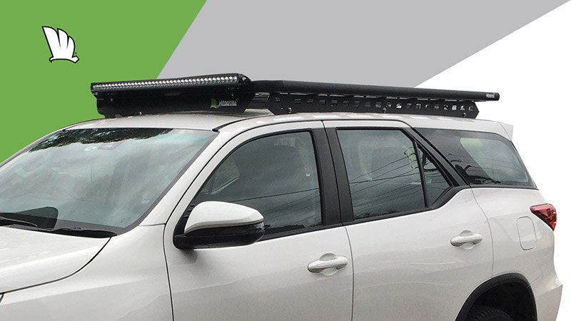Front view of the Wedgetail rack on the Fortuner showing the owner installed light bar, our standard wind deflector and the one piece mounting rails with the platform fixed on top.
