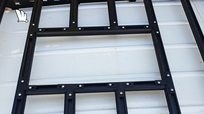 Photo from above a vent hole created using the kit. It shows two crossbars that have been cut and the support rails that have been fitted and all pieces held in place by the ‘T’ plates that have been bolted into the top channel of the rails.